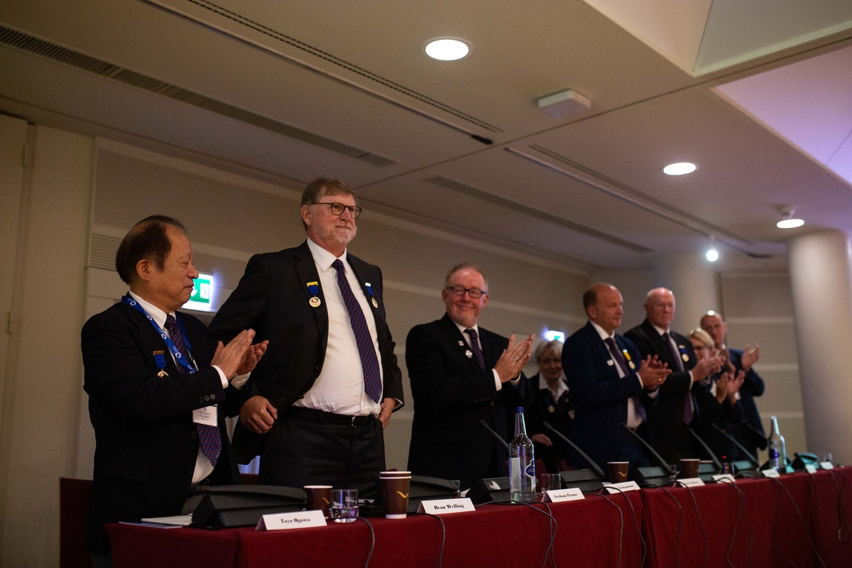 Beau Welling and the World Curling Federation Board at the World Curling Congress 2022 © WCF / Céline Stucki